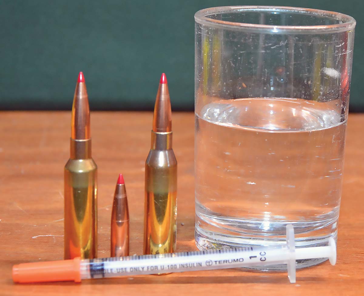 Net capacities were determined by seating Hornady 147-grain ELD-M bullets in unprimed cases to a cartridge length of 2.825 inches. Weighing them empty and weighing them again after a hypodermic syringe was used to reach through their flash holes and fill the powder cavity with water, and subtracting the former from the latter gave net capacities.
